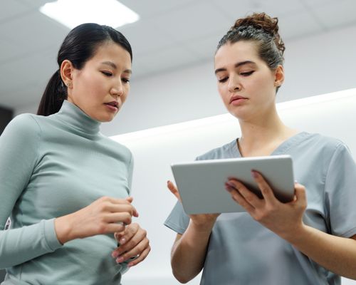 Doctor and patient reviewing health plan together on tablet