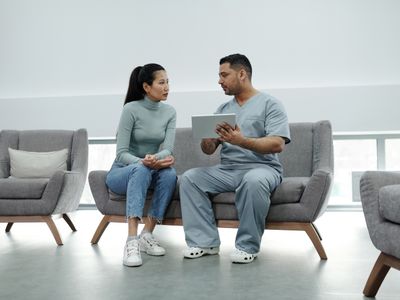 Doctor reviewing health assessment on tablet with patient